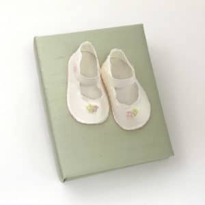 Small Hardbound Photo Album In Silk With Baby Shoes