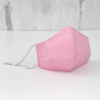Face Mask featuring pink cotton with white polka dots.
