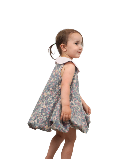 little girl wearing bubble dress gray garden