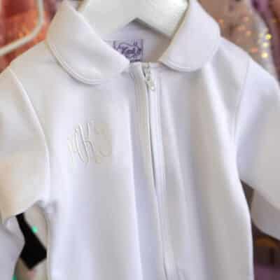 White Pima cotton baby footie with Peter Pan collar and front zipper.