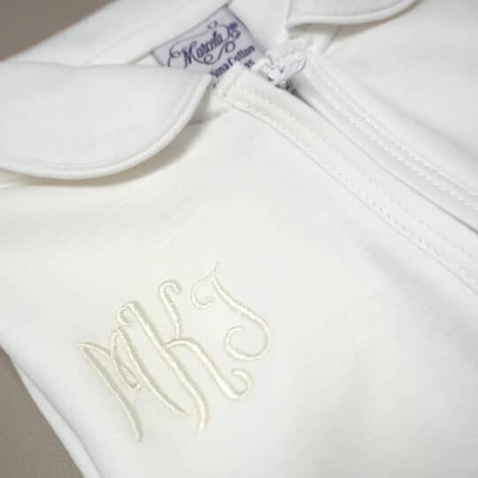 White Pima cotton baby footie with white-trimmed Peter Pan collar and front zipper.