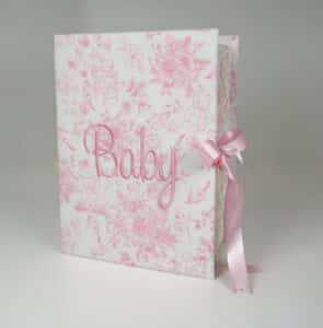 Medium baby keepsake box in Beary Blossoms Toile print, wrapped in pink floral cotton fabric, shown closed with a bow accent.