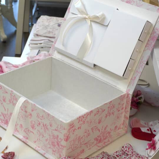 Medium baby keepsake box in Beary Blossoms Toile print, wrapped in pink floral cotton fabric, shown open with a bow accent.
